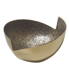 a large metal bowl sitting on top of a white table