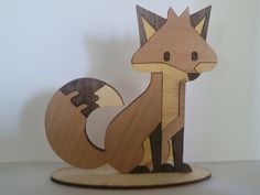 a wooden sculpture of a fox sitting on top of a table