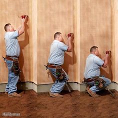 three men are working on the wall with tools