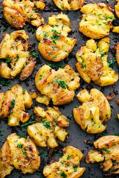 roasted potatoes with parsley and herbs on a baking sheet, ready to be eaten