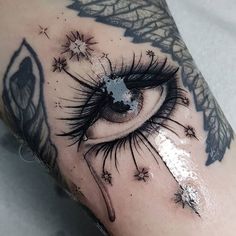 an eye with stars on it is seen in this tattoo design by the talented artist