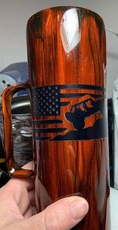 a person holding a coffee mug with an american flag on it