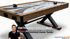 a man is sitting in front of a table with an air hockey game on it