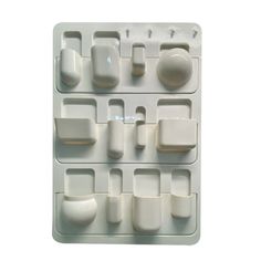 an assortment of white plastic objects on a white background