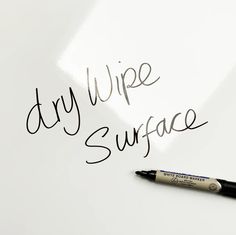 a dry wipe surface with writing on it and a black marker next to it that says dry wipe surface