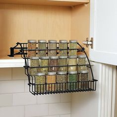 an organized spice rack in the corner of a kitchen cabinet with spices and seasonings on it