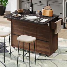 a kitchen island with two stools in front of it and bottles on the counter