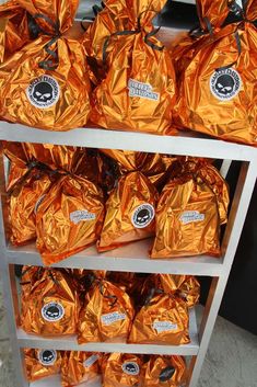 a shelf filled with lots of orange bags