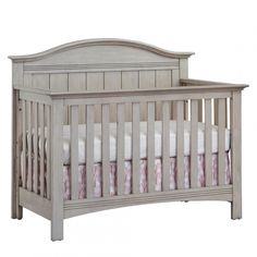 a baby crib with pink and white bedding on the bottom row, in front of a white background