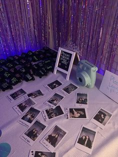 a table topped with pictures and photos next to a photo frame on top of a table