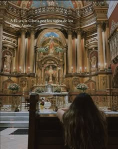 a woman sitting in front of a church alter