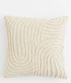 a white pillow with wavy lines on the front and back of it, against a white background