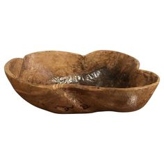 a wooden bowl with metal foil in it