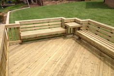 a wooden bench sitting on top of a wooden deck