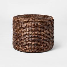 a woven basket with lid on white background