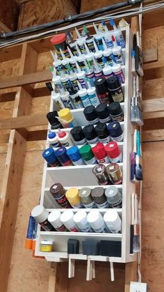 an overhead view of a paint rack with lots of paints and supplies on it's shelves