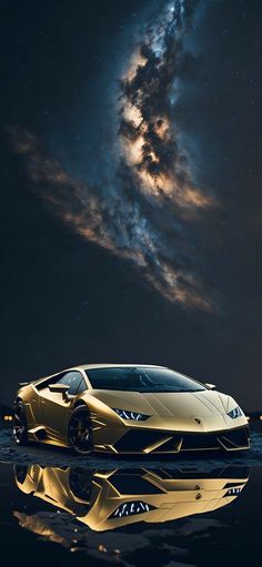 a gold colored sports car in front of a night sky