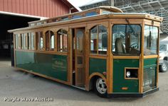 an old style trolley is parked in front of a building