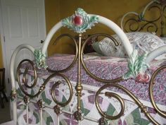 a bed with an ornate metal frame and headboard