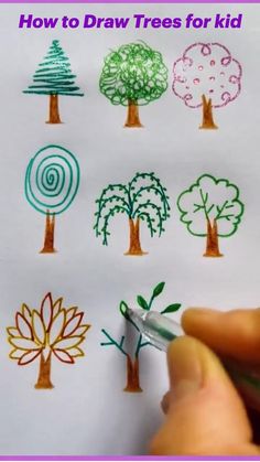 someone is drawing trees on paper with crayons