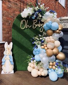 a balloon arch with blue, white and gold balloons