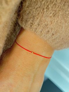 This red string bracelet is made from silk cord and solid 14K gold, 2 mm bead. Wish bracelet is a beautiful way to give someone you care for a wish. All they have to do is make a wish and then tie the cord around their wrist. When the cord finally wears down and breaks the wish is released and will come true - so they say! Details: * 14K solid gold in front, bead in the middle and 2 beads on the tassel is made from gold vermeil. Waterproof Silk String * Adjustable clasp stainless steel metal. 🎁 Red Cord Bracelet, Red String Of Fate, Tom Y Jerry, Silk Bracelet, Bracelet Couple, Red Bracelet, Bracelets Handmade Diy, Red String Bracelet, Red String