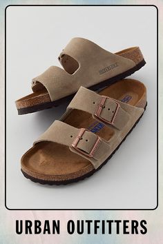 The legendary two-strap design from Birkenstock. The Arizona combines iconic style with signature comfort, featuring an additional soft layer in the anatomically formed footbed with integrated latex foam cushion. Nubuck leather upper with individually adjustable metal pin buckles. Content + Care Leather, cork, EVA Spot clean Imported Size + Fit True to size Medium/Narrow width | Birkenstock Arizona Soft Footbed Leather Sandal in Taupe, Women's at Urban Outfitters Comfortable Double Strap Leather Footbed Sandals, Soft Layer, Birkenstock Sandals Arizona, Soft Layers, Iconic Style, Birkenstock Arizona, Designer Sandals, Strap Design, Nubuck Leather