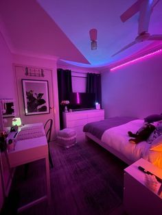 a bedroom with purple lighting and a bed in the corner, along with a desk