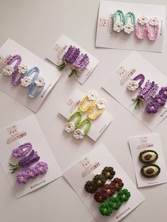 several crocheted letters are displayed on cards