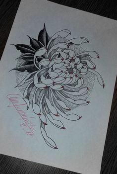 a drawing of a flower is shown on a piece of paper