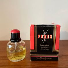 Description:  A first edition of Paris by Yves Saint Laurent, complete with its rare box. This 50ml bottle is half full, making it a valuable piece for collectors. History: The first edition of Paris is particularly prized for its original formulation, which is richer and more complex than later versions. The fragrance embodies the elegance and timeless charm of the French capital, and the 1983 release remains a symbol of YSL's iconic style. Vintage Parfum, Vanity Storage, Iconic Style, Vintage Perfume, Toiletry Storage, Style Icons, Yves Saint Laurent, Perfume Bottles, Saint Laurent