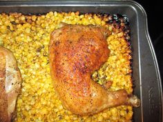 chicken and corn cooking in a pan on the stove