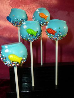 four blue cake pops with fish on them