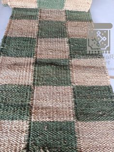 a green and brown plaid rug on the floor