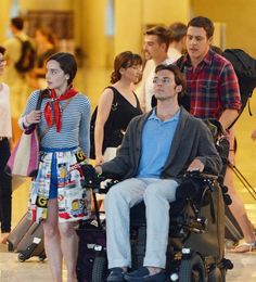 a man in a wheel chair with people behind him