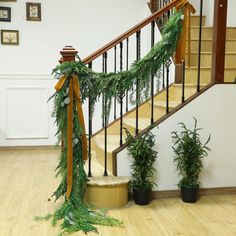 the stairs are decorated with greenery and ribbons