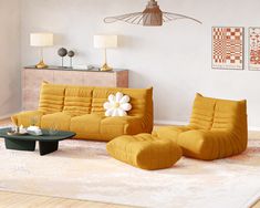 a living room filled with furniture and a flower on the couch in front of it