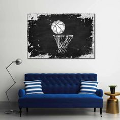 a living room with a blue couch and a basketball hoop on the blackboard wall