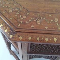 an ornate wooden table with gold decorations on it