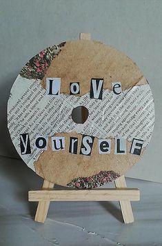 a piece of wood with the words love yourself on it