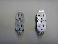 two electrical outlets are shown with red and white wires