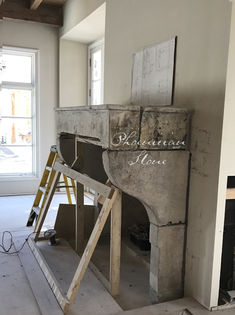 an unfinished fireplace in the middle of a room