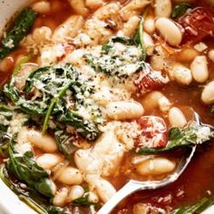 a white bowl filled with beans and spinach