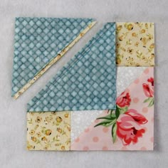 two pieces of fabric are laying on top of each other, one is blue and the other has pink flowers