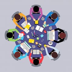 an overhead view of people sitting at a round table with books and notebooks on it