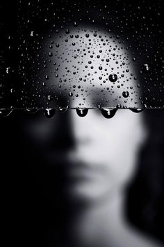 a woman's face with water droplets on it