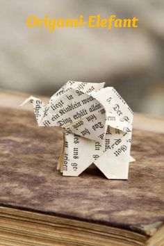 an origami elephant on top of a book with the title, origami - elephant