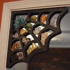 a mirror that has rocks in it and is hanging on the side of a wall