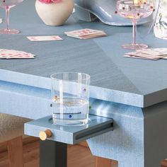 a blue table topped with a glass of water