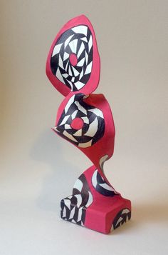 a sculpture made out of red paper with black and white designs on the bottom half